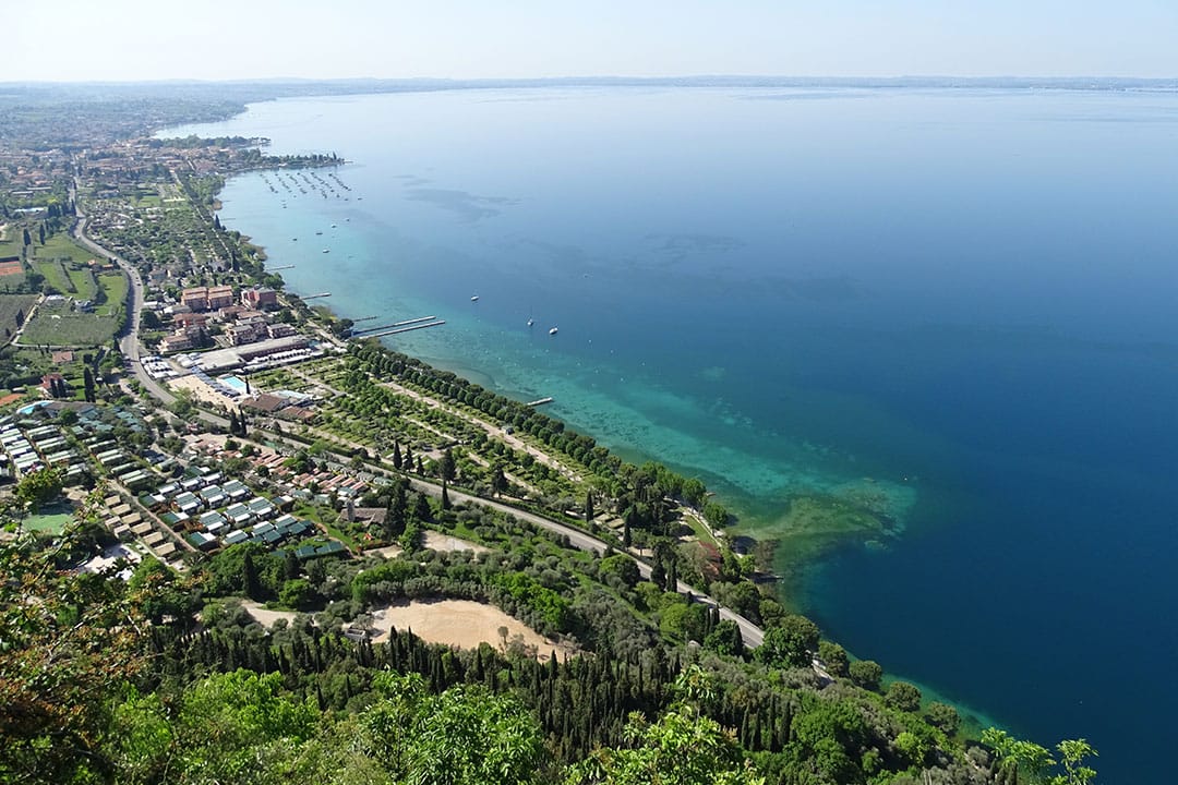 Aerial view of Lake Garda near Verona showcasing lush greenery and tranquil waters.